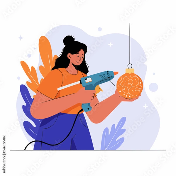 Obraz Young woman using a glue gun to decorate an ornament indoors  