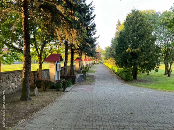 Fototapeta The Way of the Cross of Jesus with prayers commemorating his victory over alcoholism in the garden at the Minor Basilica of Our Lady of Listening Patiently in Rokitno, Poland