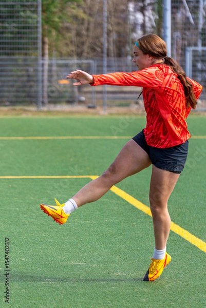 Obraz Girl soccer player. Girl in sports uniform on the soccer field. Football concept.