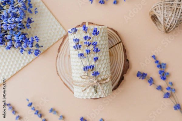 Obraz Beeswax candle with lavender tied on wood slice flatlay