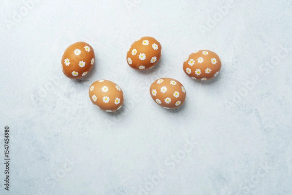 Obraz Hand-painted Easter eggs with daisies on light background. Easter bacground.