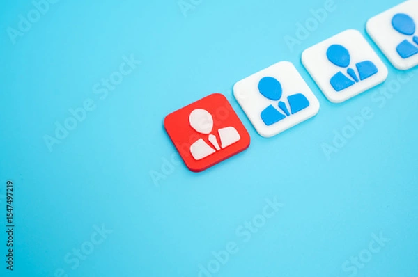 Fototapeta The employee highlighted in red among others. Staff reduction, dismissal. Job insecurity, or workforce restructuring. Corporate downsizing, individual vulnerability, human resource in times of crisis.
