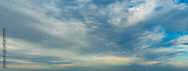 Fototapeta Background with calm blue sky and white cumulus clouds. Relaxing backdrop on the theme of weather and climate.