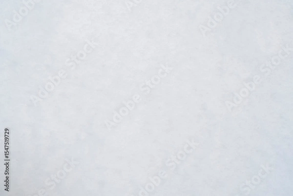 Fototapeta Background with uneven white snow. Winter texture with lumps of snow.