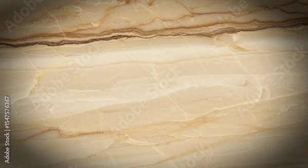 Fototapeta A close up of a light beige and brown marble surface with natural veins and subtle color variations