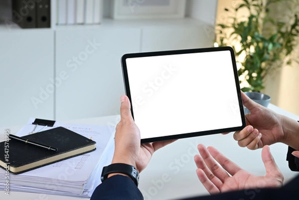Obraz Close up of business team working analysis brainstorm together tablet blank white screen placed at office. Mock up.