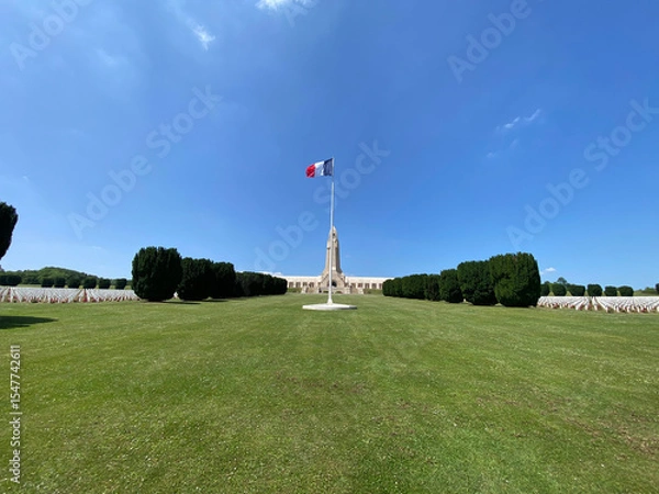Obraz View of the Douaumont Ossuary from the military cemetery in Verdun, France, under a clear sky, commemorating World War I soldiers