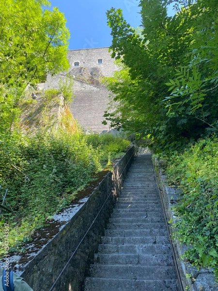 Obraz Dramatic perspective view of the steep staircase leading up to the Dinant citadel in Belgium, with stone steps and handrails under daylight.