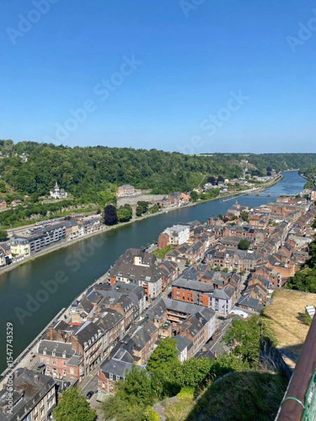 Obraz Aerial view of Dinant, Belgium, from the top of the citadel on a clear day, overlooking the Meuse River, cityscape, and surrounding landscape.