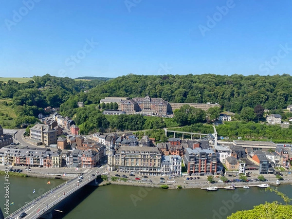 Obraz Aerial view of Dinant, Belgium, from the top of the citadel on a clear day, overlooking the Meuse River, cityscape, and surrounding landscape.