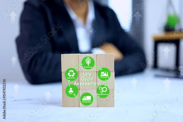 Fototapeta Life cycle assessment LCA concept with businessman show a wooden block arrange the cycle of products footprint from start to end process on the working desktop