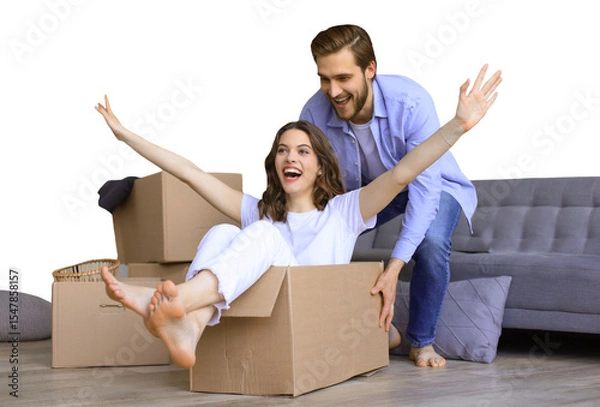 Fototapeta Happy couple is having fun with cardboard boxes in new house at moving day, woman riding sitting in cardboard box while man pushing it on a transparent background