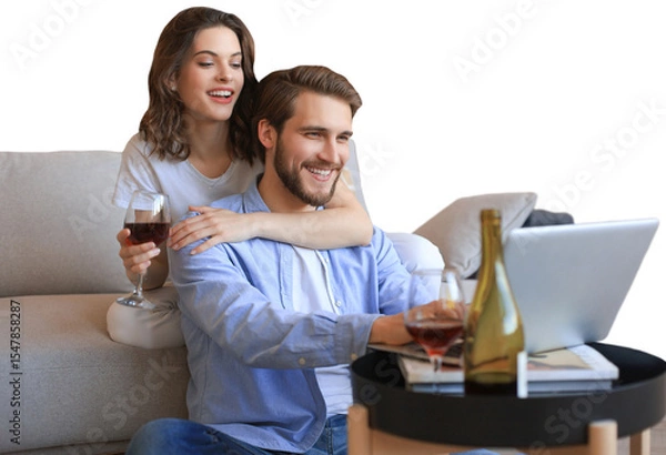 Fototapeta Happy couple sitting, relaxing on floor in living room, using laptop for online shopping together, watching movie on a transparent background