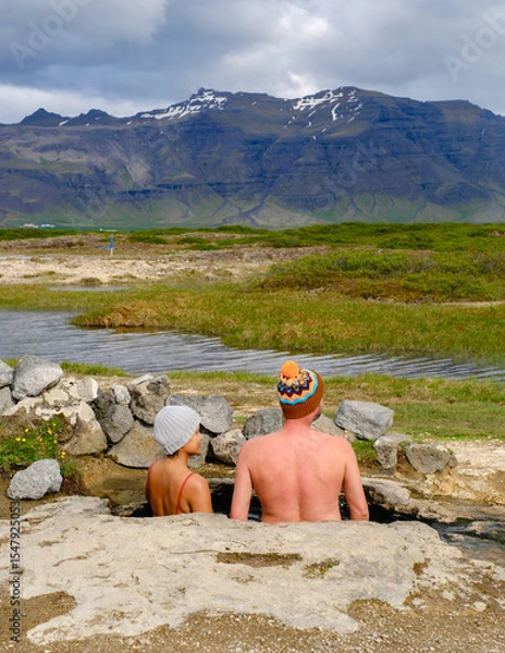 Fototapeta Relaxing in Landbrotalaug Hot Spring surrounded by stunning Icelandic landscapes