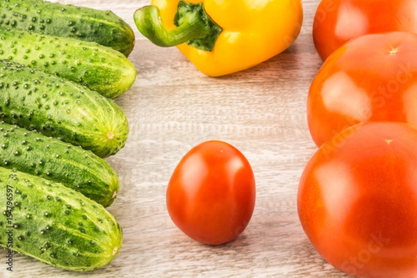 Fototapeta Cucumber, tomato, pepper and fennel on a white wooden background close up.