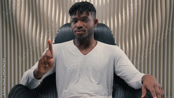 Fototapeta Serious confident African American ethnic man male guy gamer modern futuristic white room indoors cyberspace looking at camera technology vr shaking finger no gesture forbidden not never refuse deny