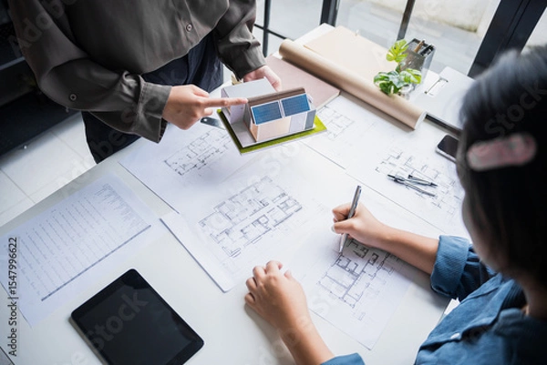 Fototapeta Engineer planning for Solar panels green energy Business man working Innovation  green eco friendly in modern office business  Planing Bio economy for business renewable energy eco friendly.