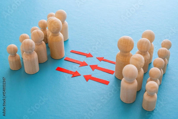 Fototapeta Concept of conflict I war between people or groups. Wooden figures gathered in two groups facing each other.