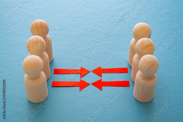 Fototapeta Concept of conflict I war between people or groups. Wooden figures gathered in two groups facing each other.