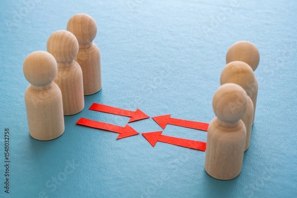 Fototapeta Concept of conflict I war between people or groups. Wooden figures gathered in two groups facing each other.
