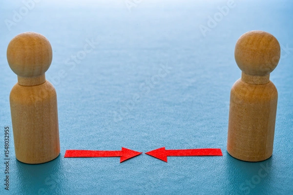 Fototapeta Concept of conflict I war between people or groups. Wooden figures gathered in two groups facing each other.