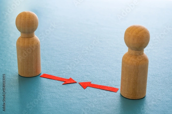 Fototapeta Concept of conflict I war between people or groups. Wooden figures gathered in two groups facing each other.