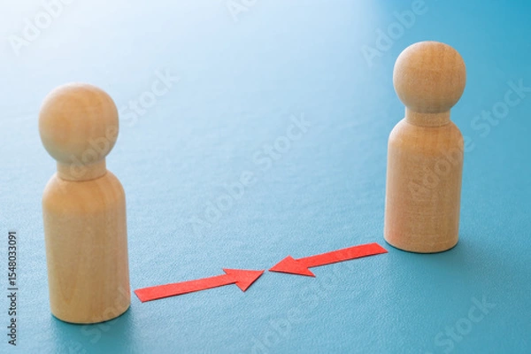 Fototapeta Concept of conflict I war between people or groups. Wooden figures gathered in two groups facing each other.