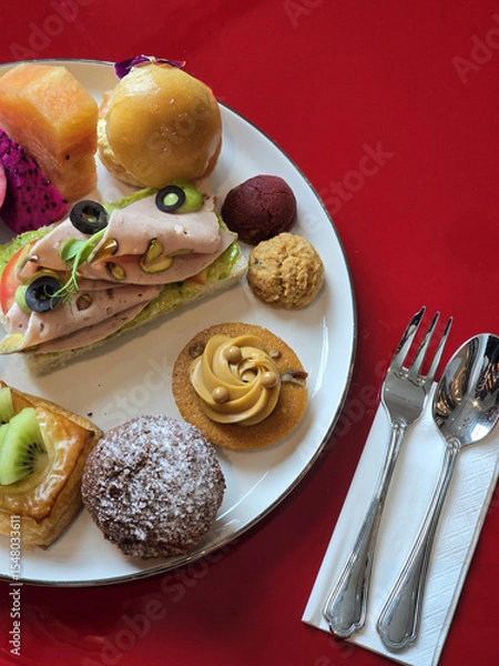 Obraz colorful plate of gourmet pastries and savory snacks, featuring variety of textures and flavors, perfect for delightful brunch experience