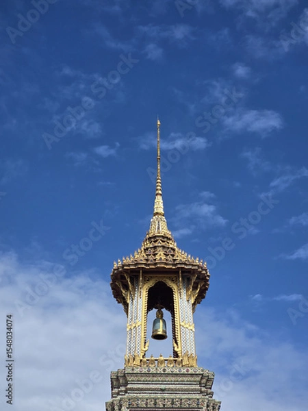 Obraz stunning temple spire reaching towards blue sky, adorned with intricate details and bell. architecture reflects cultural heritage and craftsmanship