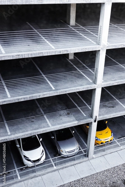 Fototapeta Looking Down on Levels of a Parking Garage with a Few Cars or Vehicles Parked