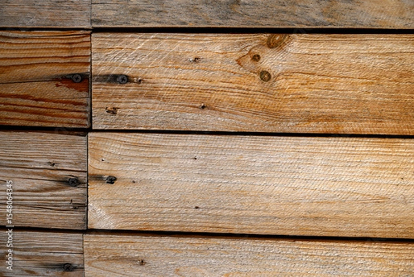 Fototapeta Wooden planks are neatly arranged horizontally, showcasing their natural grain and variety of brown tones.Visible knots and grain patterns add character and rustic charm to the surface,for copy space.
