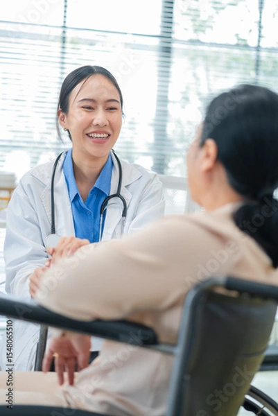 Fototapeta experienced female medical professional explains test results to a female patient during a clinic consultation. reviewing reports and discussing diagnosis and treatment options.compassionate care