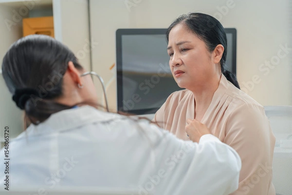 Fototapeta experienced female medical professional explains test results to a female patient during a clinic consultation. reviewing reports and discussing diagnosis and treatment options.compassionate care