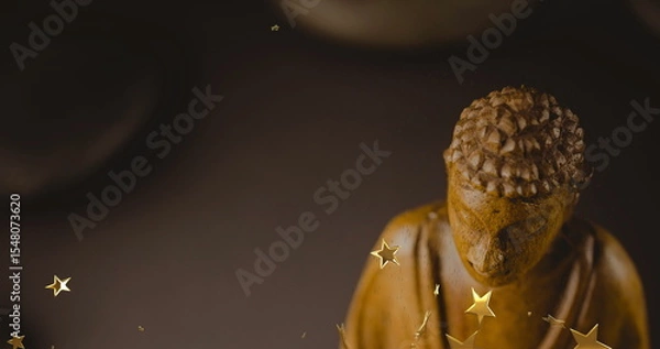 Obraz Shining carved Buddha statue radiating warm glow on display, with star-shaped confetti, copy space