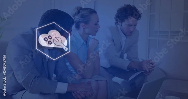 Fototapeta Business professionals reviewing documents on laptop in office lounge, with cloud-gear overlay icon
