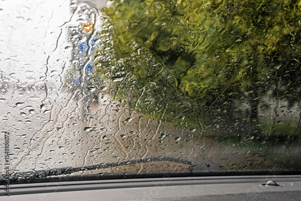 Obraz rain and tornado while driving on the road on the windshield. natural disaster