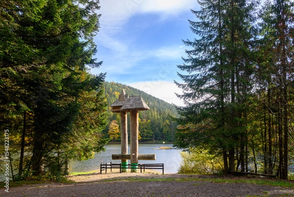 Fototapeta Mountain lake Synevir, Ukraine. View of Synevir high-altitude lake by autumn day. The leaf fall forest, lake and mountains.