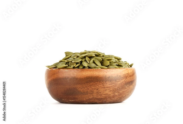 Obraz Peeled pumpkin seeds in a bowl on a white background.