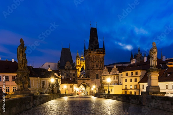 Fototapeta Charles Bridge without people in the morning in the blue hour, Malostranska Bridge Tower, the dominant feature of Charles Bridge. The illuminated Charles Bridge