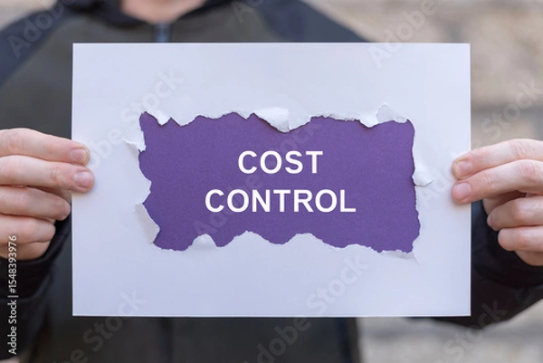 Fototapeta Person holding paper sheets banner sees the inscription: COST CONTROL. Cost and quality control, business strategy and project management concept. Cost reduction and effective enterprise.