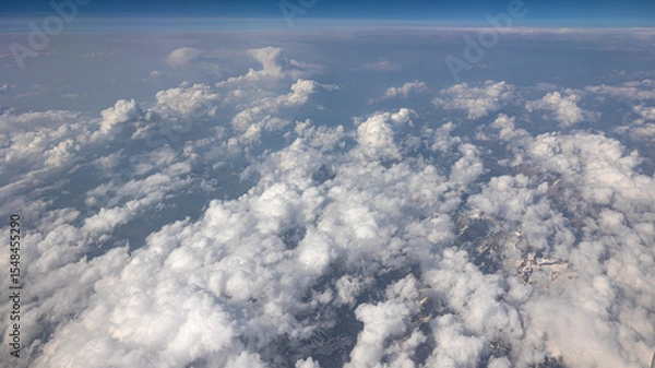 Fototapeta Experience the Captivating Aerial View of Beautiful Clouds and the Clear Blue Sky Above You