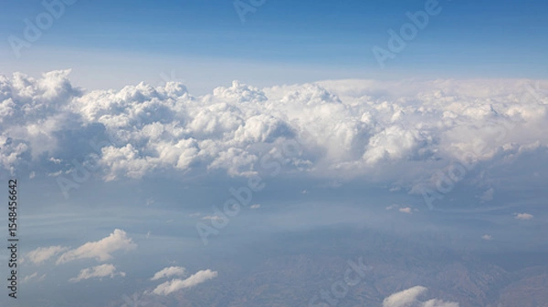 Fototapeta A Breathtaking Scenic Aerial View of Billowing Clouds Floating Above a Beautiful Landscape