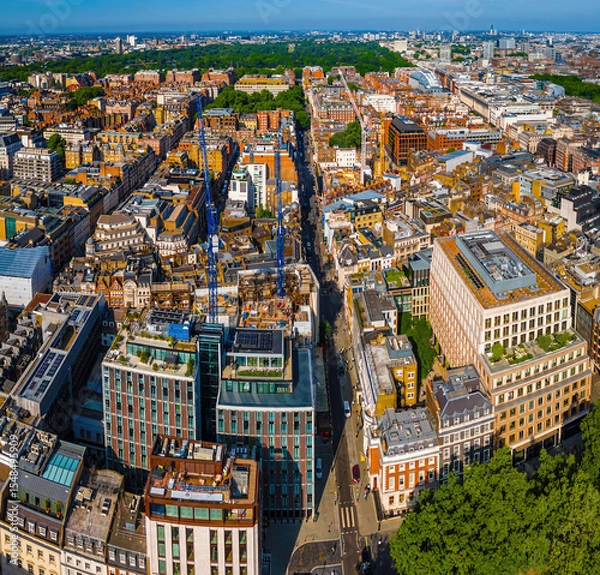 Fototapeta Aerial view of Hanover Square in London featuring green park space, surrounding classic architecture, and city streets on a clear day.