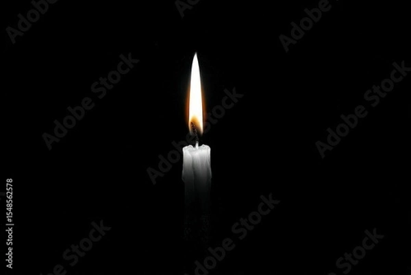 Fototapeta Illuminating candle flame dark background photography warm environment close-up tranquility and reflection