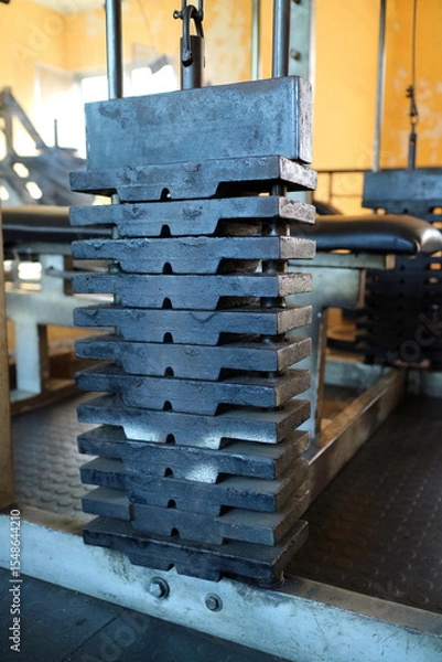 Fototapeta Close Up of Stacked Weight Plates in Gym