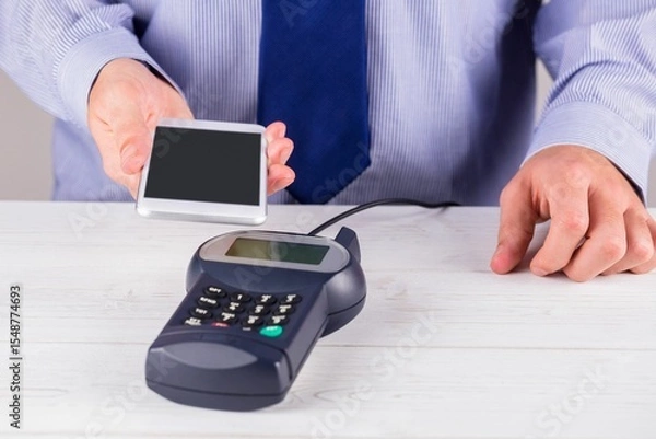 Obraz Man using smartphone to express pay