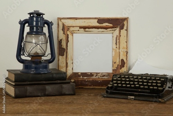Obraz Photo frame, lantern and typewriter on table