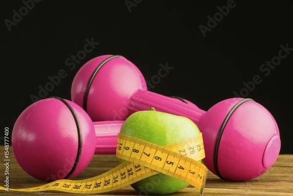 Obraz Pink dumbbells with green apple and measuring tape