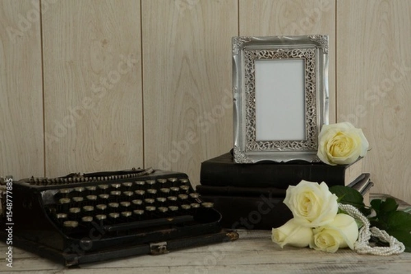 Fototapeta Photo frame, flowers and type writer on table