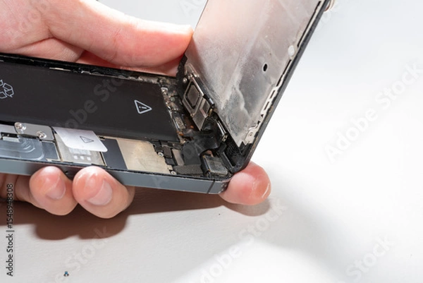 Fototapeta The smartphone was damages and need to repair  which tools smartphone that stand on white background by hands of repairman.
